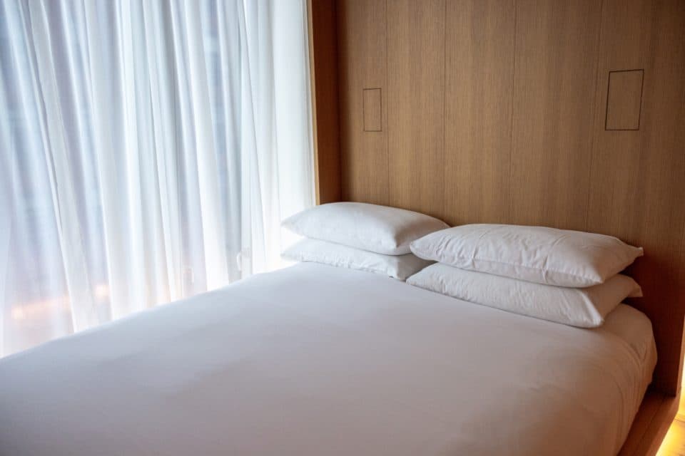 Soft pillows against a wooden headboard